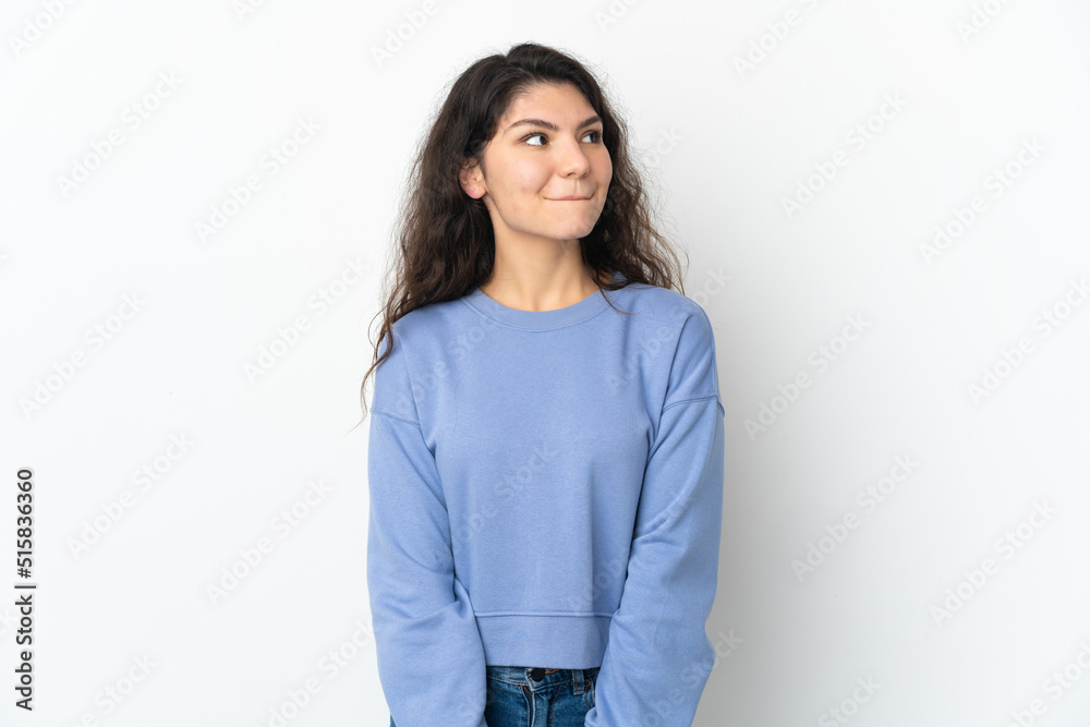 Teenager Russian girl isolated on white background having doubts while looking up Teenager Russian girl isolated on white background having doubts while looking up