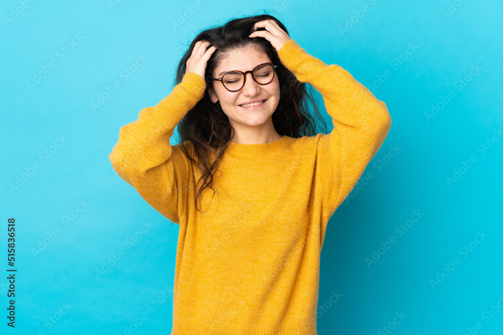 Teenager Russian girl isolated on blue background laughing Teenager Russian girl isolated on blue background laughing