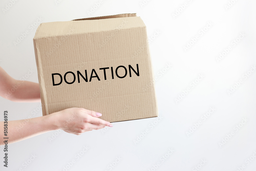 box with donations in hands on a white background box with donations in hands on a white background