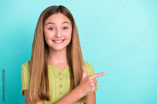 Portrait of positive person indicate fingers empty space offer promo isolated on bright turquoise color background