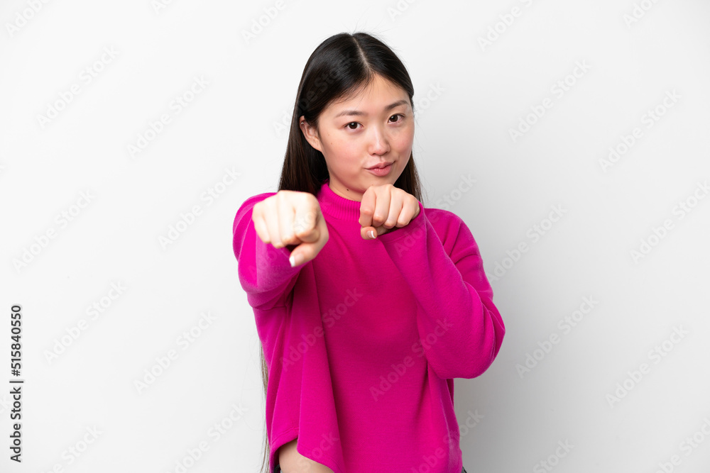 Young Chinese woman isolated on white background with fighting gesture Young Chinese woman isolated on white background with fighting gesture