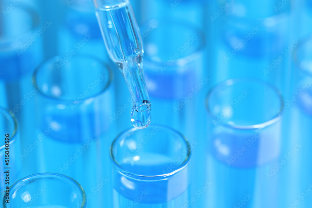 Dripping reagent into test tube with blue liquid, closeup. Laboratory analysis Dripping reagent into test tube with blue liquid, closeup. Laboratory analysis