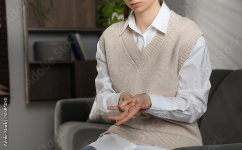 Woman suffering from trigger finger at home, closeup. Space for text photo