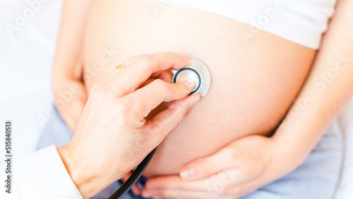 Pregnant consult doctor. Medical clinic for pregnancy consultant. Doctor examining pregnancy woman belly holding stethoscope. Concept of pregnancy, maternity, expectation for baby birth.