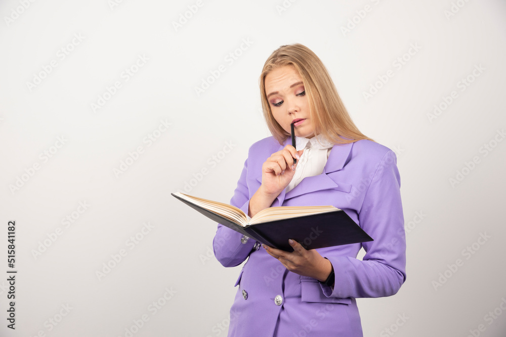 Woman looking on opened tablet with pencil on white background Woman looking on opened tablet with pencil on white background