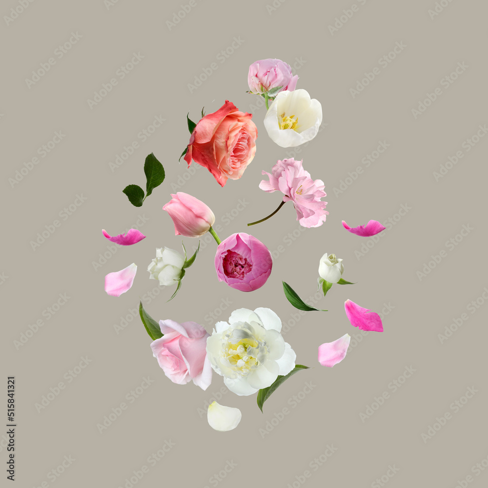 Different beautiful flowers flying on light grey background