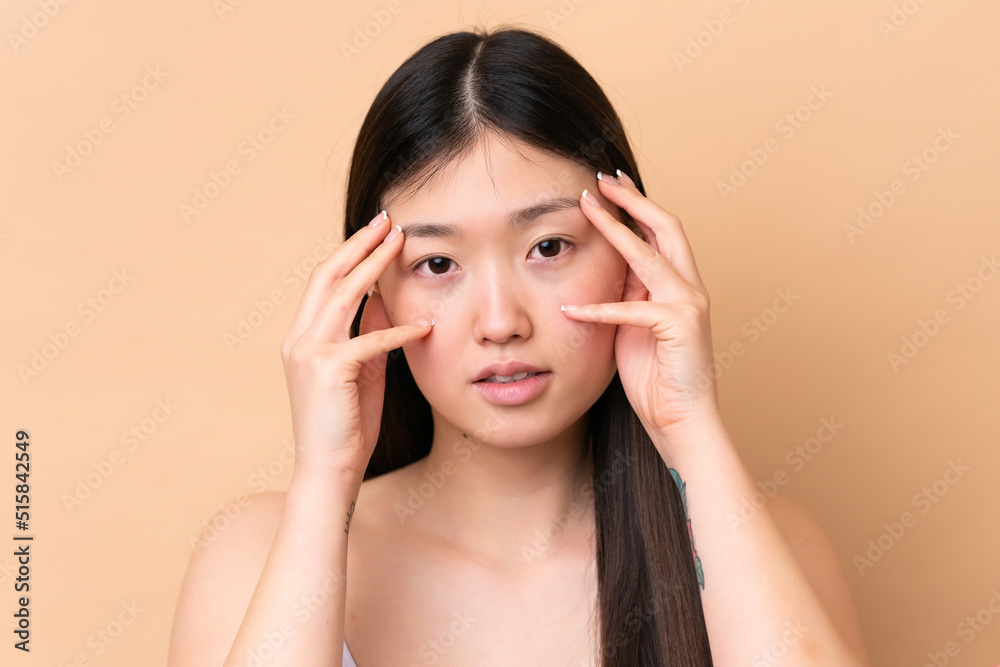 Young Chinese woman isolated on beige background . Portrait Young Chinese woman isolated on beige background . Portrait