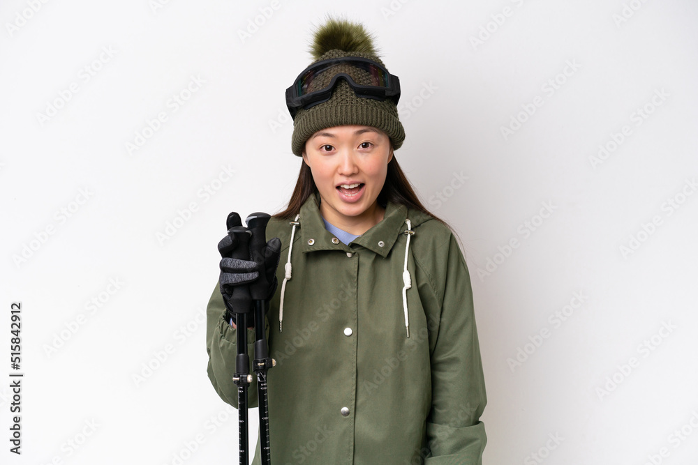 Young Chinese woman wearing winter jacket isolated on white background with surprise facial expression Young Chinese woman wearing winter jacket isolated on white background with surprise facial expression