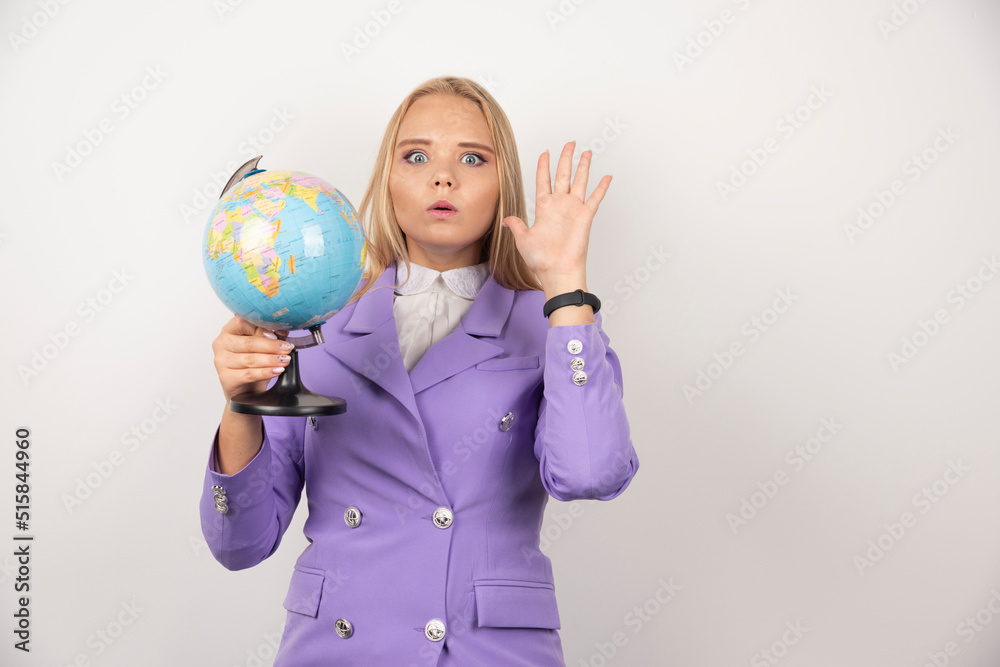 Female teacher holding globe on white background Female teacher holding globe on white background