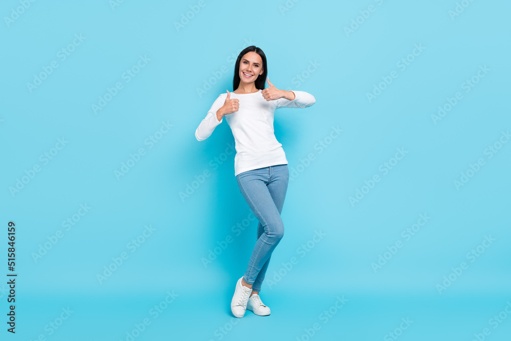 Full body photo of young girl show thumb-up approve select good advertise isolated over blue color background Full body photo of young girl show thumb-up approve select good advertise isolated over blue color background