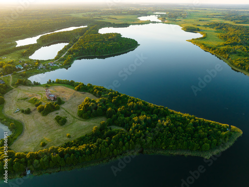 Lake in rural, aerial view. Freshwater Lakes. Abandoned Trinity Church in village of Belaya Tserkov. Lake Chereiskoye in Chereya village. Lighthouse on island. Panoramic landscape view of river.