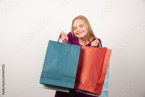 Blonde shopaholic holding colorful shopping bags © azerbaijan-stockers