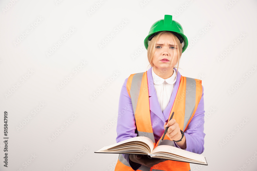 Female builder in helmet with tablet on white background Female builder in helmet with tablet on white background