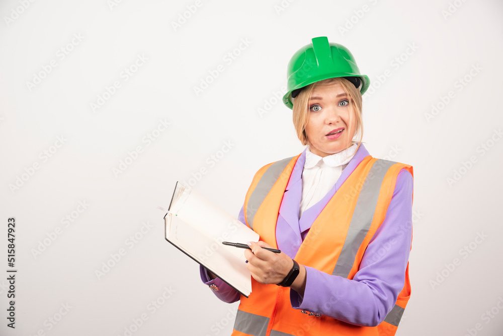 Female builder in helmet with tablet on white background Female builder in helmet with tablet on white background