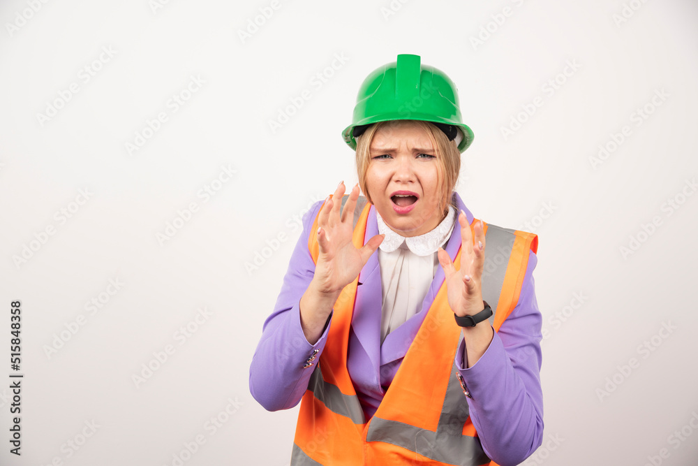 Female builder in helmet on white background Female builder in helmet on white background