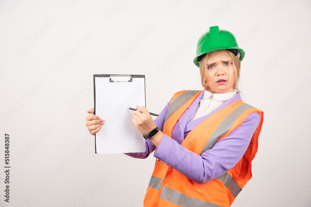 Female builder in hardhat holding tablet on white background Female builder in hardhat holding tablet on white background