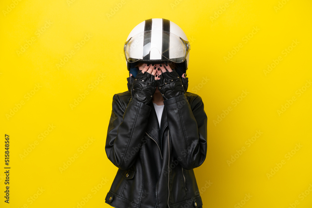 Young English woman with a motorcycle helmet isolated on yellow background with tired and sick expression Young English woman with a motorcycle helmet isolated on yellow background with tired and sick expression