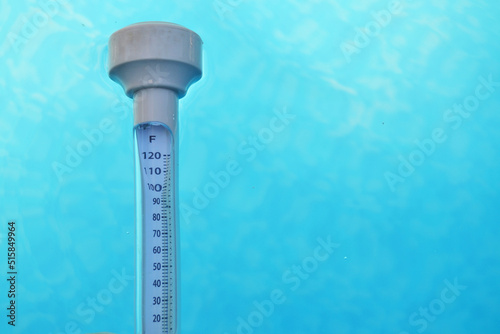 close-up of a swimming pool thermometer floating