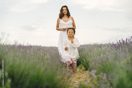 Little girl with her mother in a lavender field
