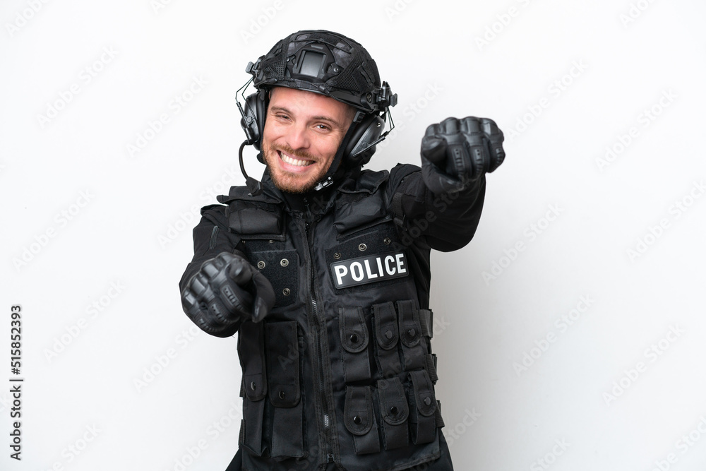Brazilian soldier man isolated on white background points finger at you while smiling