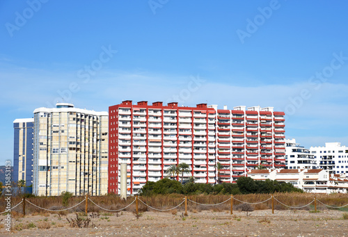 Apartments buildings in La Pobla de Farnals (Puebla de Farnals) in Valencia. Multi-storey residential buildings near sea coast. Residential buildings with rooms, windows and balconies. House on sea. © MaxSafaniuk