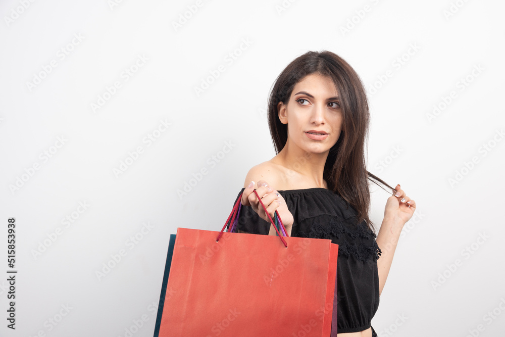 Female model posing with shopping bags on white background Female model posing with shopping bags on white background
