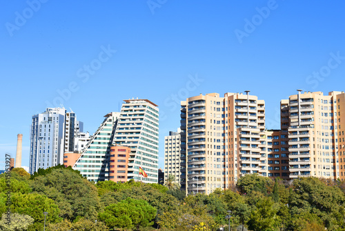 Facade house buildings at Central Park on Turia River. Residential building and apartments. Spain modern architecture. Green trees on Buildings architecture background. House with window and balcony.