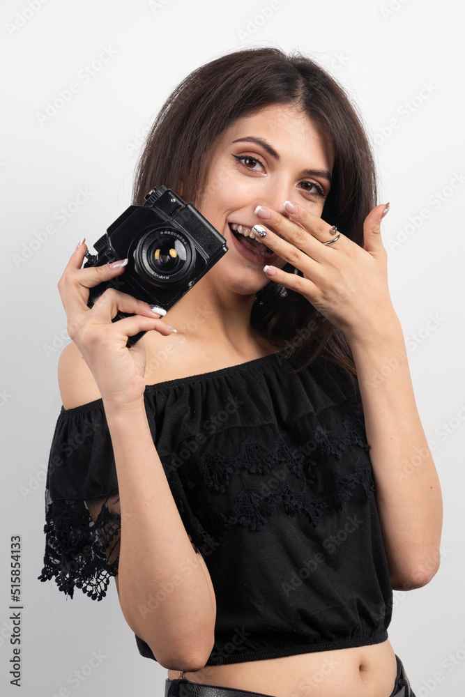 Pretty woman holding camera and laughing Pretty woman holding camera and laughing