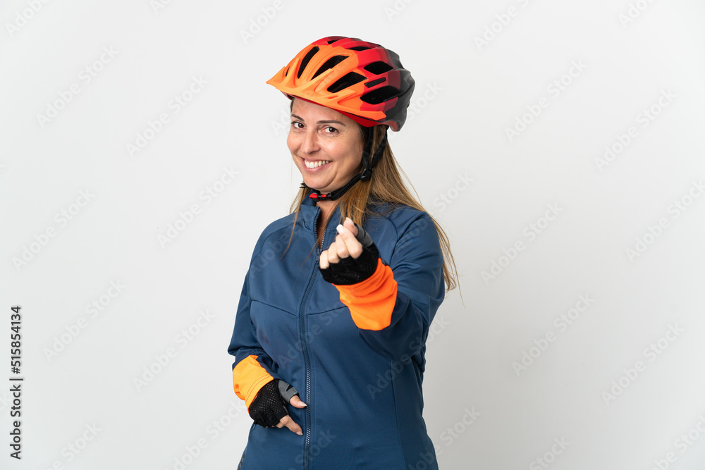 Middle age cyclist woman isolated on white background making money gesture Middle age cyclist woman isolated on white background making money gesture