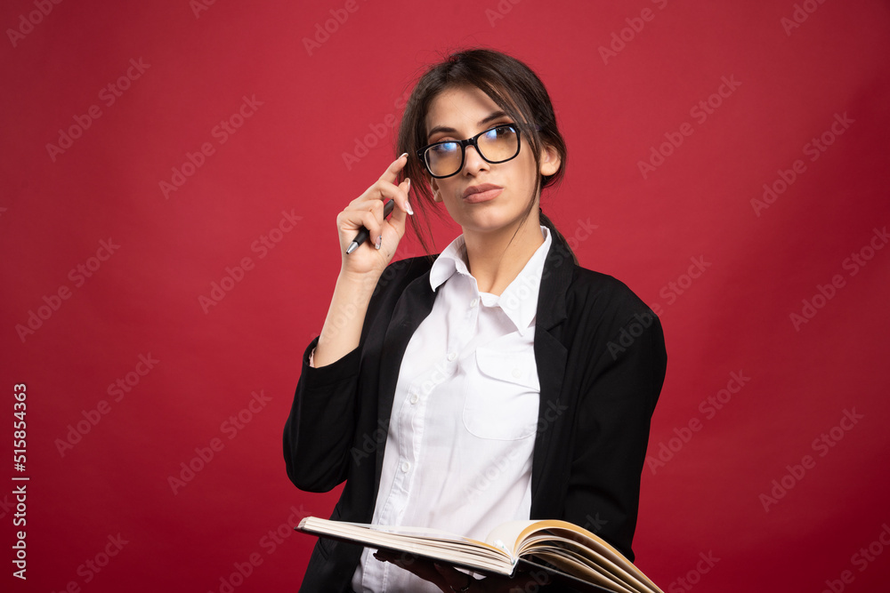 Young businesswoman in glasses holding book Young businesswoman in glasses holding book