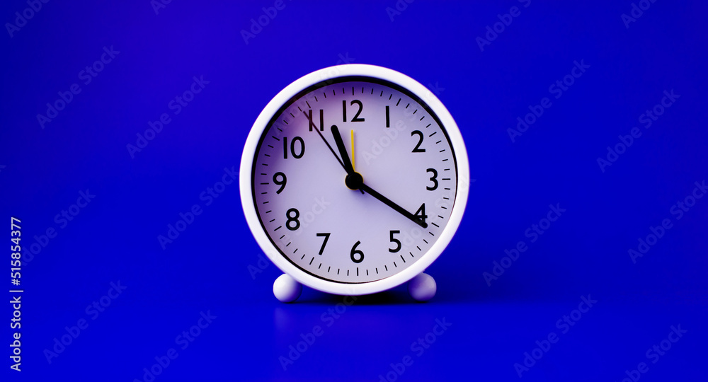white clock placed on a blue background The concept of time and the importance of time white clock placed on a blue background The concept of time and the importance of time