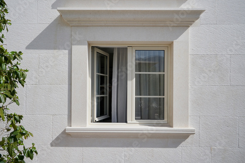 Beige wall with open elegant PVC window