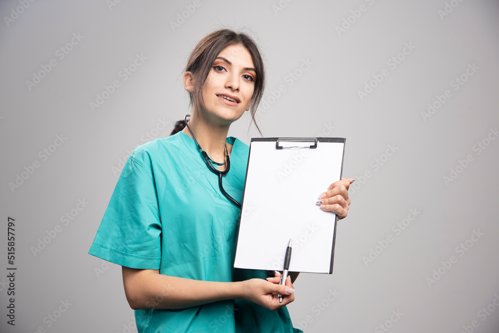 Female doctor with clipboard looking at camera Female doctor with clipboard looking at camera