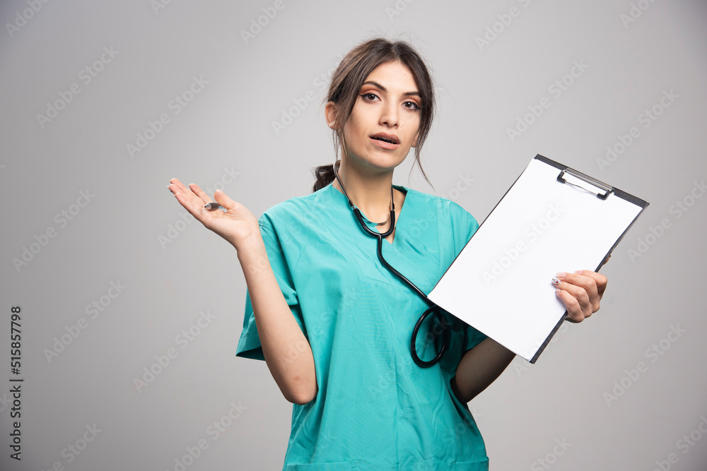 Female doctor with clipboard looking at camera Female doctor with clipboard looking at camera