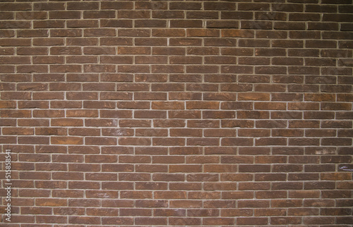 Dark brown brick wall. Empty space for the text. Abstract background and texture.