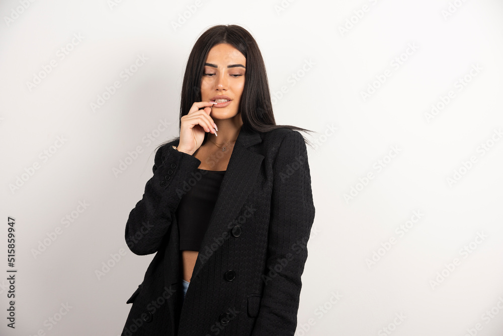 Portrait of brunette girl biting her finger Portrait of brunette girl biting her finger