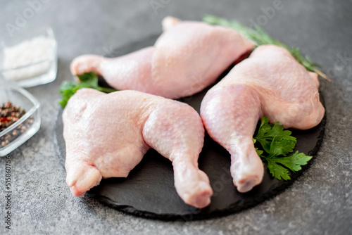 raw chicken legs on stone background