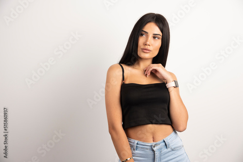 Portrait of stylish woman standing on white background