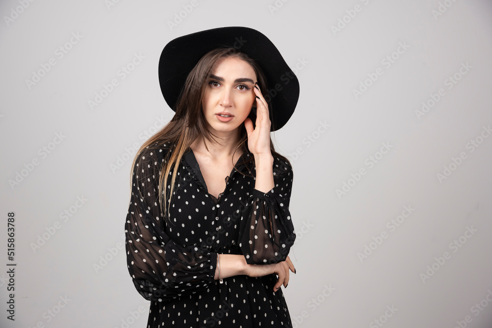 Young woman in black dress looking at camera