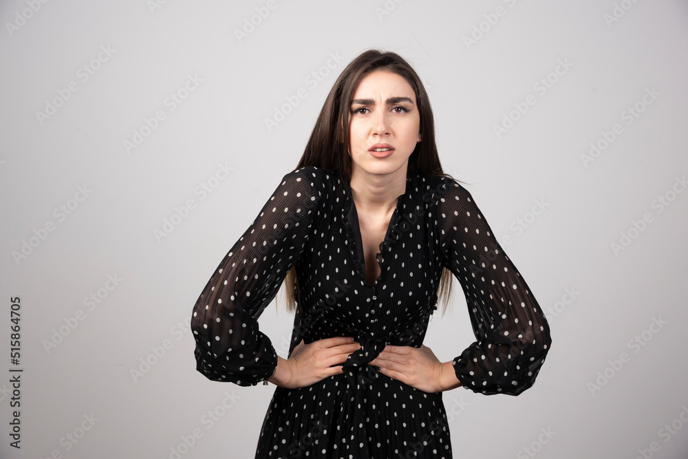 Beautiful woman saying holding her stomach because of feeling painful Beautiful woman saying holding her stomach because of feeling painful