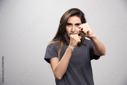 Young woman standing and posing with fists