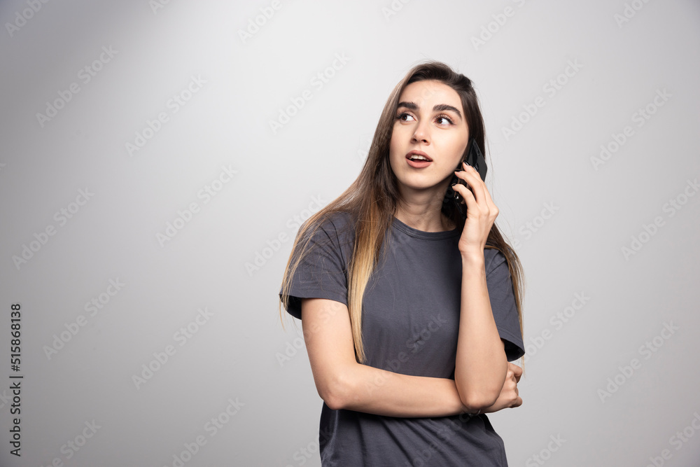 Portrait of a girl talking on mobile phone and looking away Portrait of a girl talking on mobile phone and looking away
