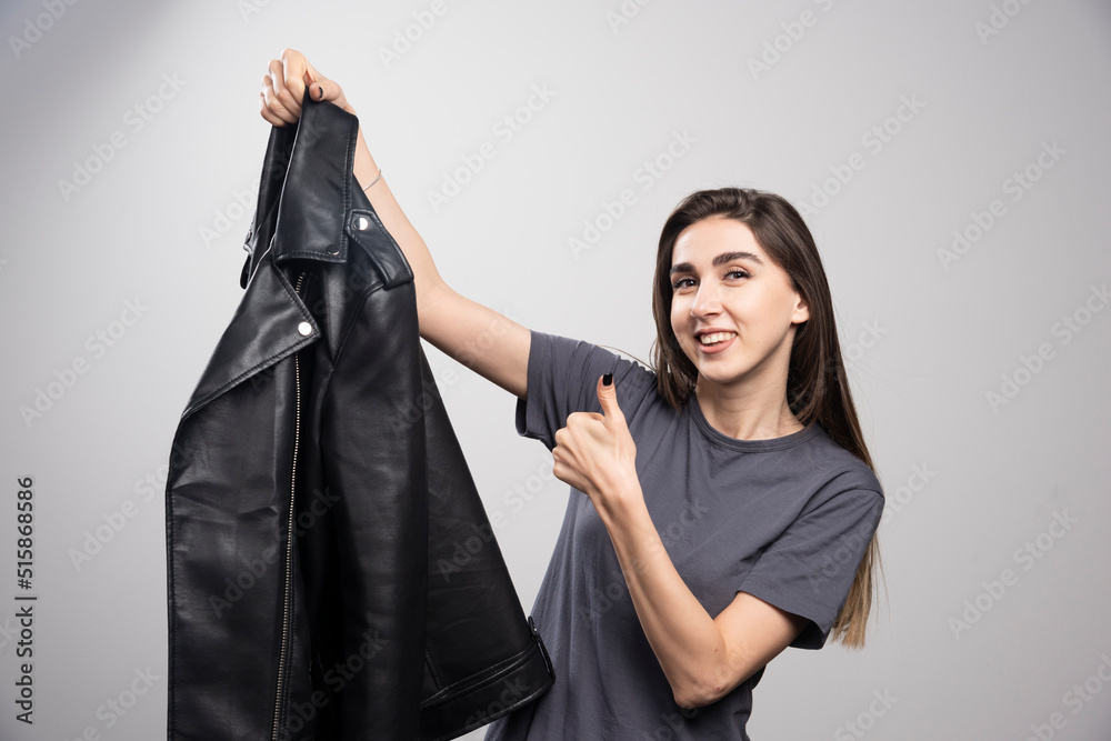 Model with black leather jacket showing a thumb up Model with black leather jacket showing a thumb up