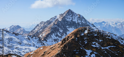 The snow-capped peaks and glaciers of the Aosta Valley and Piedmont during a sunny winter day near the town of Biella, Italy - February 2022.