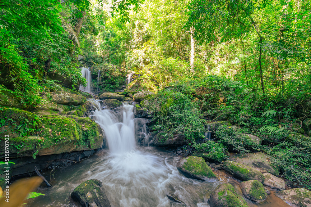 Beautiful waterfall scenic flow from the top into the bottom in the green forest. Beautiful waterfall scenic flow from the top into the bottom in the green forest.