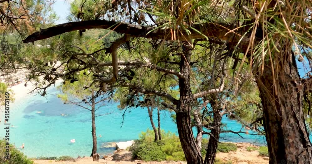 Amazing panoramic view of natural beauty turquoise clear sea water, pebbles beach, tourists on the beach on a summer day. Clear blue sky. Tripiti Beach, Greece island Thassos. 4K footage. Amazing panoramic view of natural beauty turquoise clear sea water, pebbles beach, tourists on the beach on a summer day. Clear blue sky. Tripiti Beach, Greece island Thassos. 4K footage.