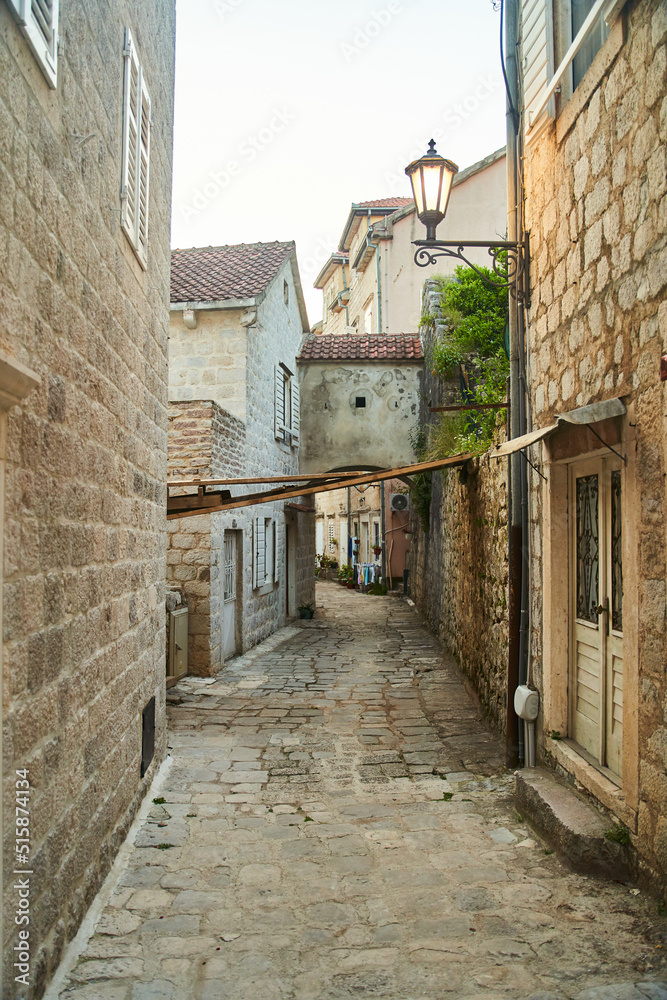 Empty narrow street with ancient stone buildings in old town Herceg Novi, Montenegro. High quality photo