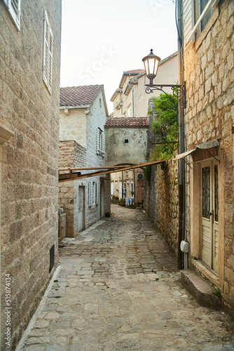 Empty narrow street with ancient stone buildings in old town Herceg Novi, Montenegro. High quality photo © Dima Anikin