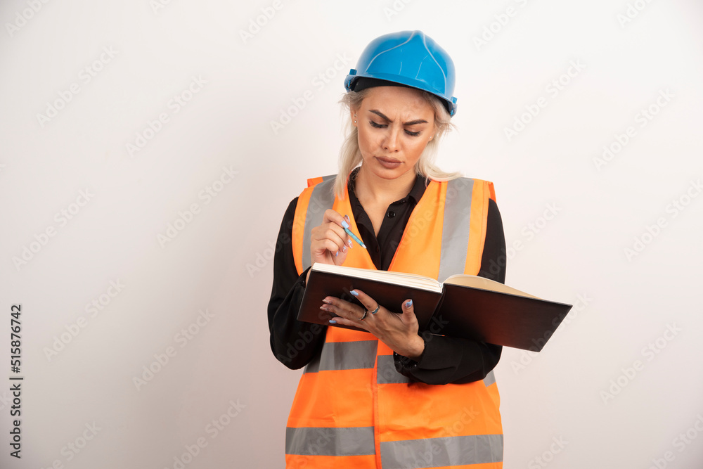 Displeased worker checking important notes on white background Displeased worker checking important notes on white background
