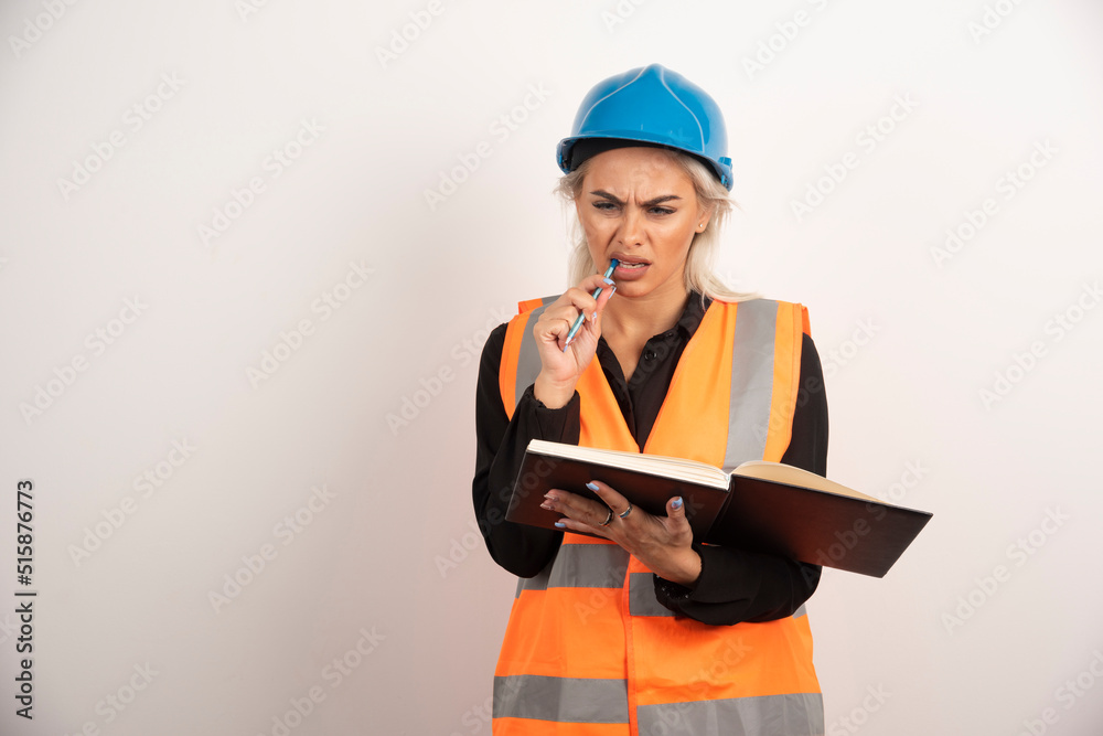 Displeased worker checking important notes on white background Displeased worker checking important notes on white background